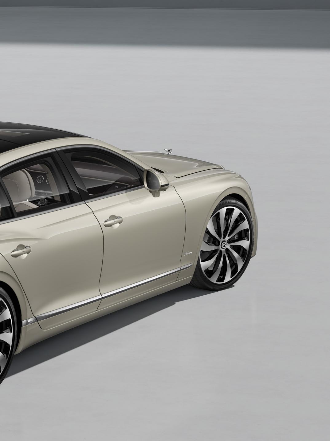 Front three-quarter shot of the Bentley Flying Spur Azure in White Sand with Bright Chrome Exterior detailing.