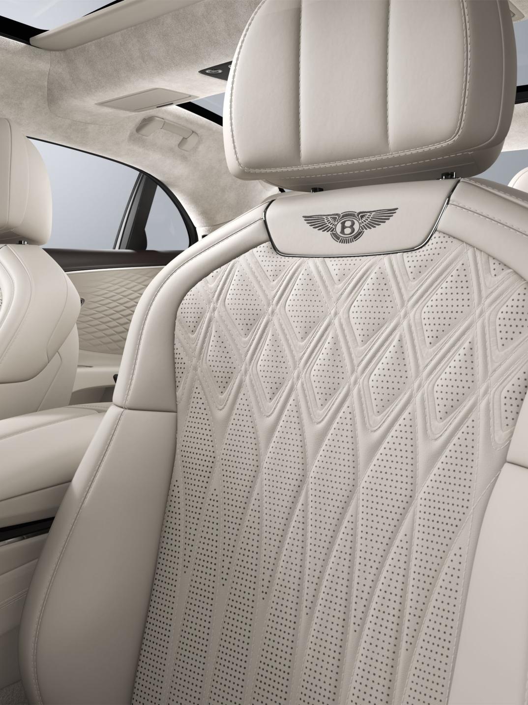 Interior view of the Bentley Flying Spur Azure driver’s seat in Linen and Burnt Oak.