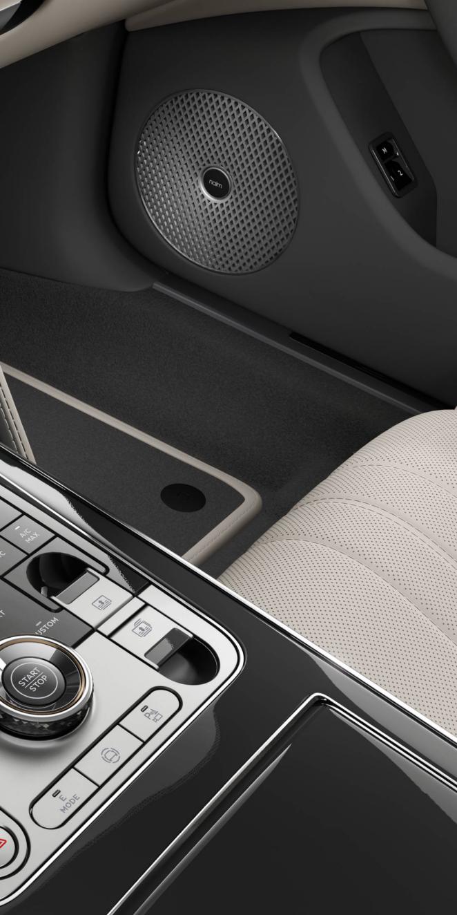 Close-up of the Naim speaker inside the Bentley Flying Spur S with Linen and Gravity Grey interior trim.