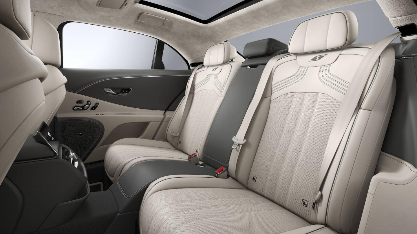 Rear passenger seat view inside the Bentley Flying Spur S with Linen and Gravity Grey upholstery and 4+1 seat configuration.