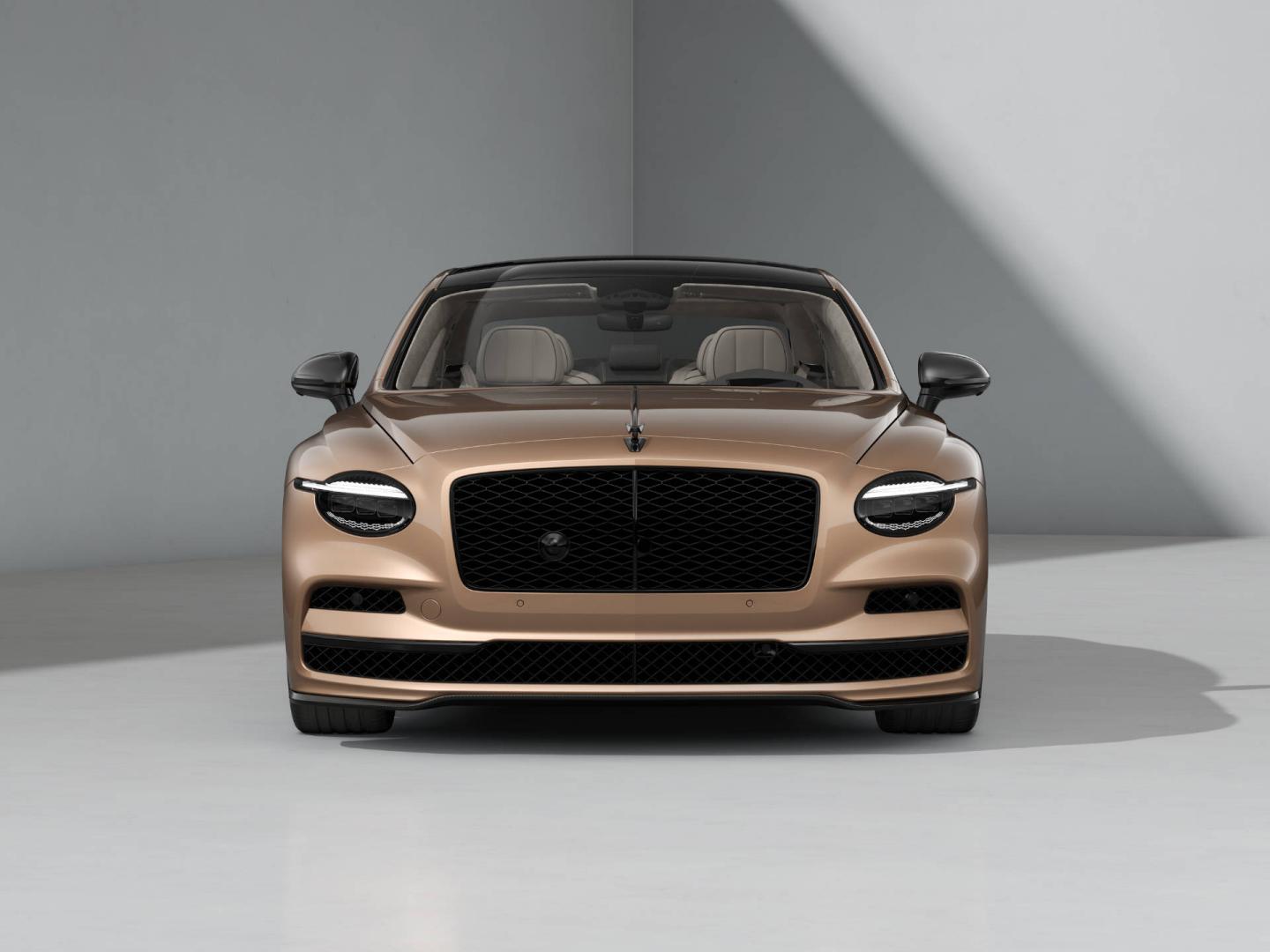 Front-on shot of the Bentley Flying Spur S in Rose Gold with Blackline Specification and dark exterior detailing.