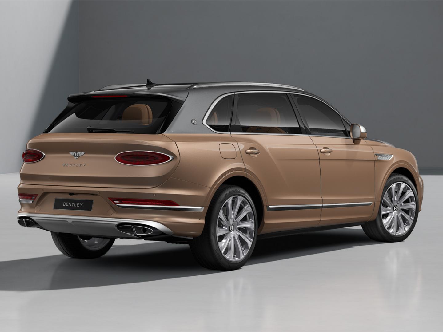 Rear three quarter of a Bentley Bentayga EWB Mulliner in Magnetic over Rose Gold exterior paints